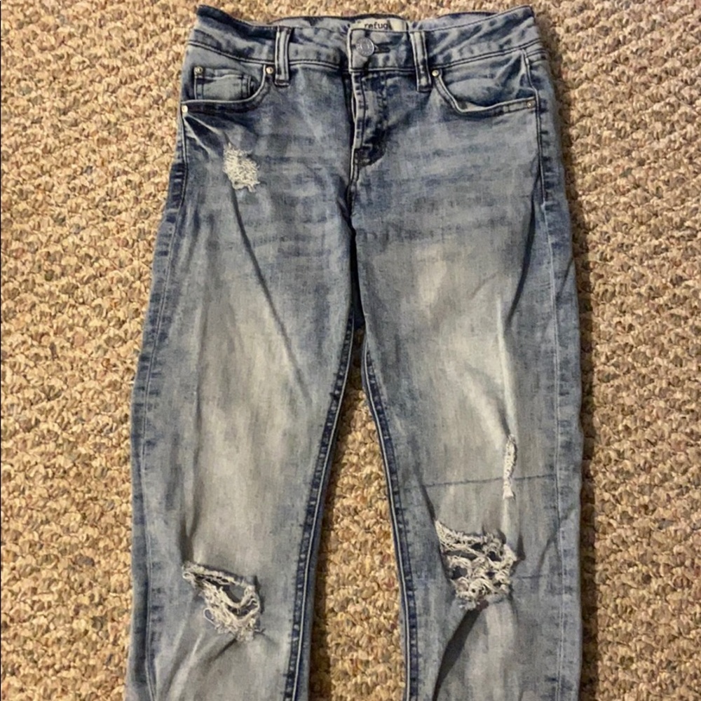 Bleach washed ripped blue jeans